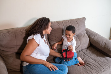 Mother and son playing with the word love on mother's day