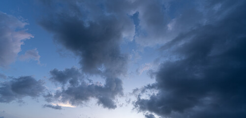 Obraz premium Beautiful view of sky with clouds at sunrise. Partly cloudy. Colorful sunset. Natural sky background texture, beautiful color.