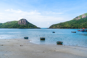 Fototapeta na wymiar Ben Dam Port in Con Dao island, Vietnam with beautiful blue sea blue sky mountain and colorful boats.
