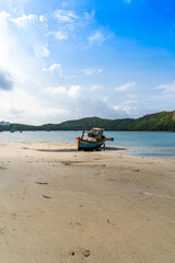 Fototapeta premium Ben Dam Port in Con Dao island, Vietnam with beautiful blue sea blue sky mountain and colorful boats.