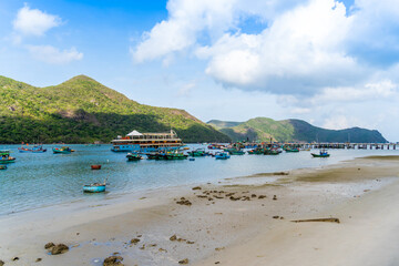 Ben Dam Port in Con Dao island, Vietnam with beautiful blue sea blue sky mountain and colorful boats.