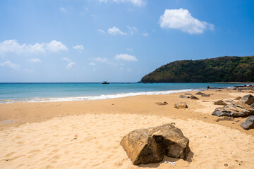 Beautiful Dam Trau beach in Con Dao island, Vietnam. Coastal view with waves, coastline, clear sky and road, blue sea, tourists and mountain.