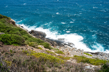 Fototapeta premium a peaceful Con Dao island, Vietnam is a Vietnamese island heaven. Coastal view with waves, coastline, clear sky and road, blue sea, tourists and mountain