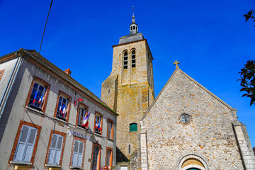 Church of Saint Genevieve overlooking the City Hall of the small village of Montigny Lencoup in the...