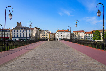 Symmetric view of the cobbled street on the market bridge spanning the Marne river in the city center of Meaux in Seine et Marne near Paris, France