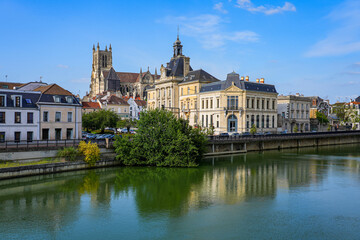 Fototapeta na wymiar Reflection of Saint Stephen's cathedral overlooking the City Hall of Meaux in the Marne river in the Seine et Marne Department near Paris, France