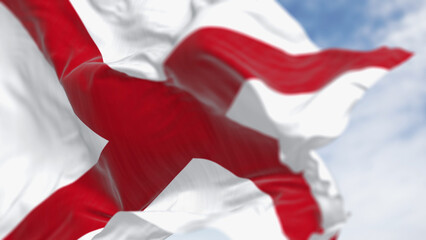 The state flag of Alabama waving in the wind on a clear day