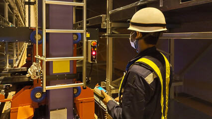 Technician is testing the system of machine in industrial factory.