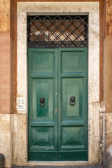 An old decorated vintage door in historical centre of Rome, Italy