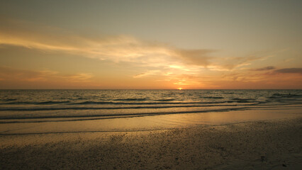 Sunset dark at Florida beach. Calm water with yellow sky from sun. St. Pete Beach Pass a grille