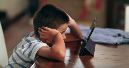 Boy watching movie on tablet. Child watches content online on tech device