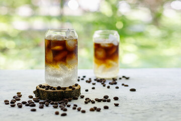 Cold black coffee with tonic and ice in glass. Summer drink on nature background