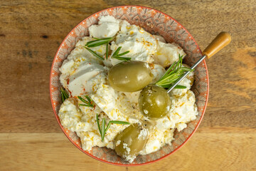 Feta Olive Salad with fresh rosemary in ceramic bowl.