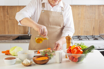 man preparing healthy vegetarian food  on  table in  kitchen