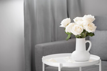 bouquet of white roses in white jug in modern interior