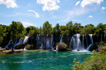 Famous Kravica waterfall in Bosnia and Herzegovina. Spring time. Wide streaming water falling from...