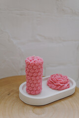 Fototapeta na wymiar Pink wax candles in the shape of flowers