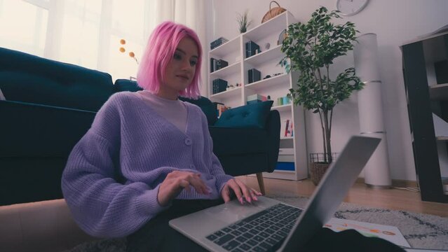 Young creative woman working on laptop, apparel designer occupation, freelance