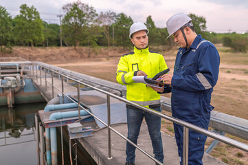 Environmental engineers work at wastewater treatment plants,Water supply engineering working at Water recycling plant for reuse,Technicians and engineers discuss work together.