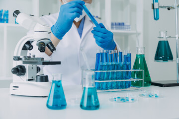 medical or scientific researcher researching and experimenting Multi-colored solution, vial and...