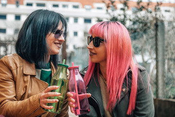 friends in the street toasting with a drink