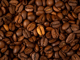 Background from roasted coffee beans. Scattered coffee beans. Coffee beans close up.