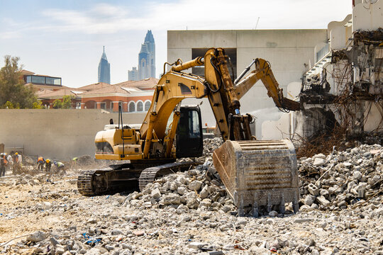 excavator removes debris in a demolition site of an old building