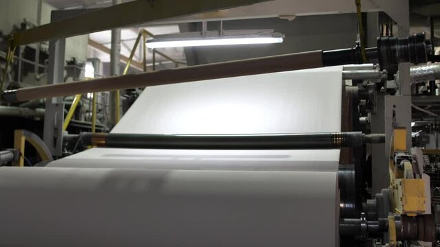 Factory for the production of paper rolls for hygiene. Manufacture of paper towels and toilet paper. Roll winding machine.