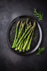 Traditionally grilled green asparagus with herbs as a top view on a modern design plate with copy space, generate ai