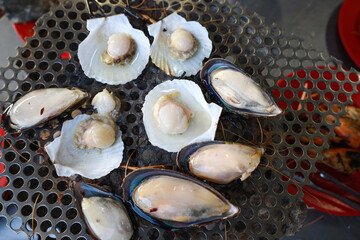 Grilled scallops, served on their shells, are a delectable seafood delicacy in Thailand.
