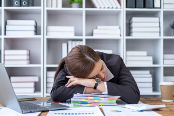 Overworked and tired businesswoman sleeping over document in office, chronic fatigue syndrome, tired business woman sleeping on desk