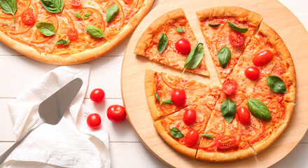 Composition with tasty cut pizza margarita on table, top view