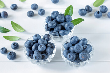 fresh blueberries in glass bowls on a white background close-up. background with ripe fresh blueberries.