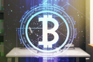 Double exposure of creative Bitcoin symbol and modern desktop with laptop on background. Cryptocurrency concept