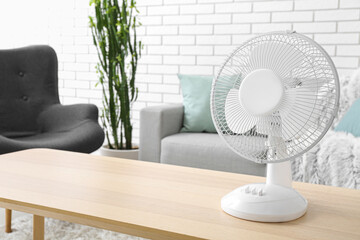 Modern electric fan on table in living room
