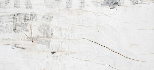 Old grunge torn collage urban street posters creased crumpled paper placard texture background. Ripped faded paper backdrop surface placard. White, gray, black colors background