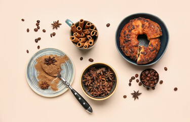 Composition with cinnamon sticks, powder, coffee beans, anise stars and cake on light background