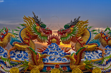 Colourful multicoloured dragon on top of a  temple in Patong Phuket Thailand. beautiful blue green...