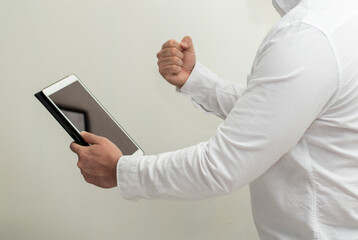 Portrait of person holding a tablet making gesture in white background