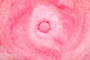 Fototapeta premium Bath bomb dissolving in pink water