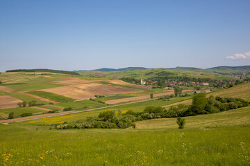Fototapeta na wymiar Landscape with a small village between hills in Transylvania - Romania