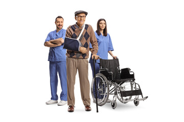 Male and female nurse with a wheelchair standing behind an elderly injured male patient