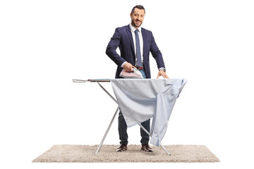 Businessman ironing a shirt and smiling