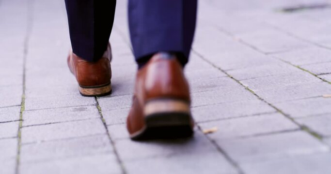 Business man, shoes and walking in street for travel, morning commute and ground outdoor in city from the back. Closeup, corporate executive and feet in road, town or formal fashion on urban sidewalk