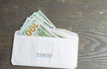 Money taxes savings in envelope bills to pay held in hand cash, copy space textured background...
