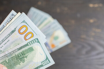 Money taxes savings in envelope bills to pay held in hand cash, copy space textured background horizontal image 