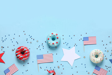 Composition with donuts, USA flags and confetti on blue background. Independence Day celebration