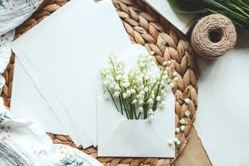 Envelope with lilies of the valley and aesthetic decor, holiday concept