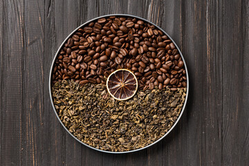 Green tea and coffee grains on a dark wooden background top view.