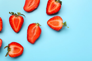 Slices of fresh strawberries on blue background